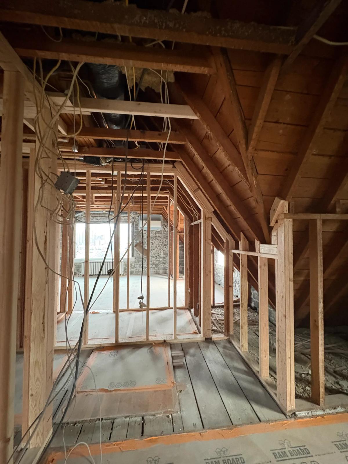 Upper floor opened to the rafters with existing wiring kept in place