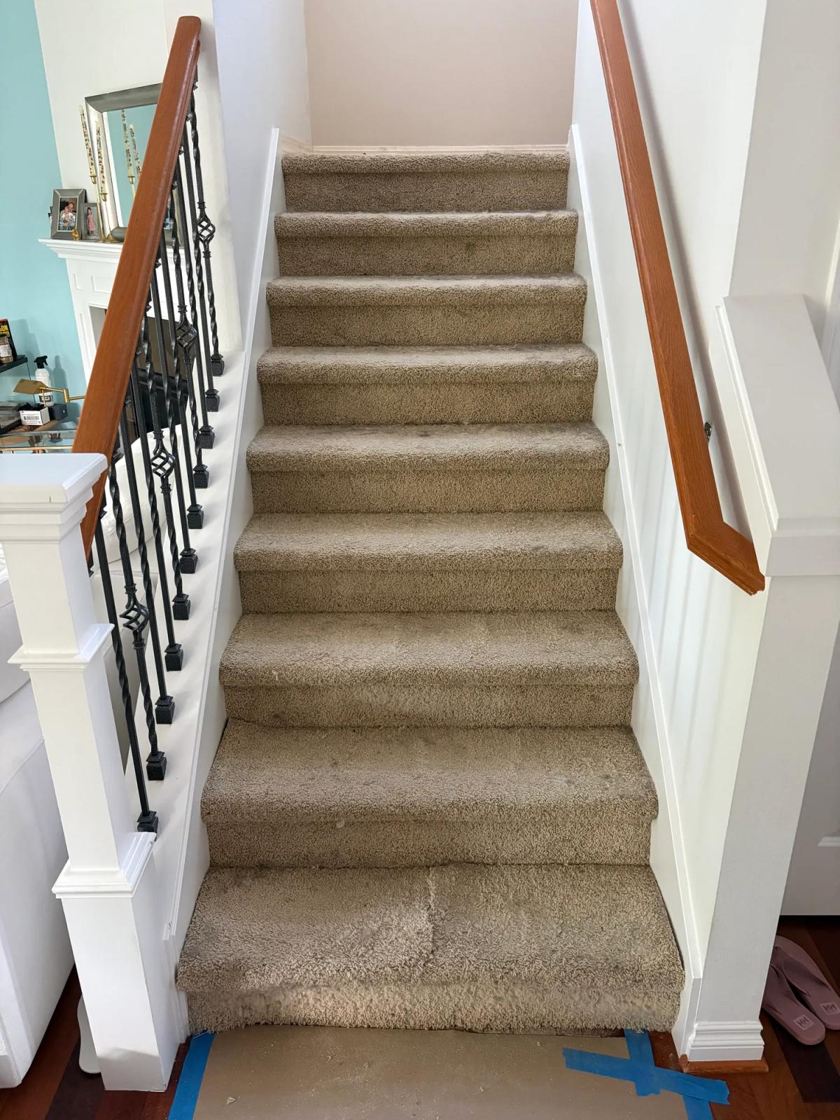 Carpet replaced with custom hardwood stair treads., before