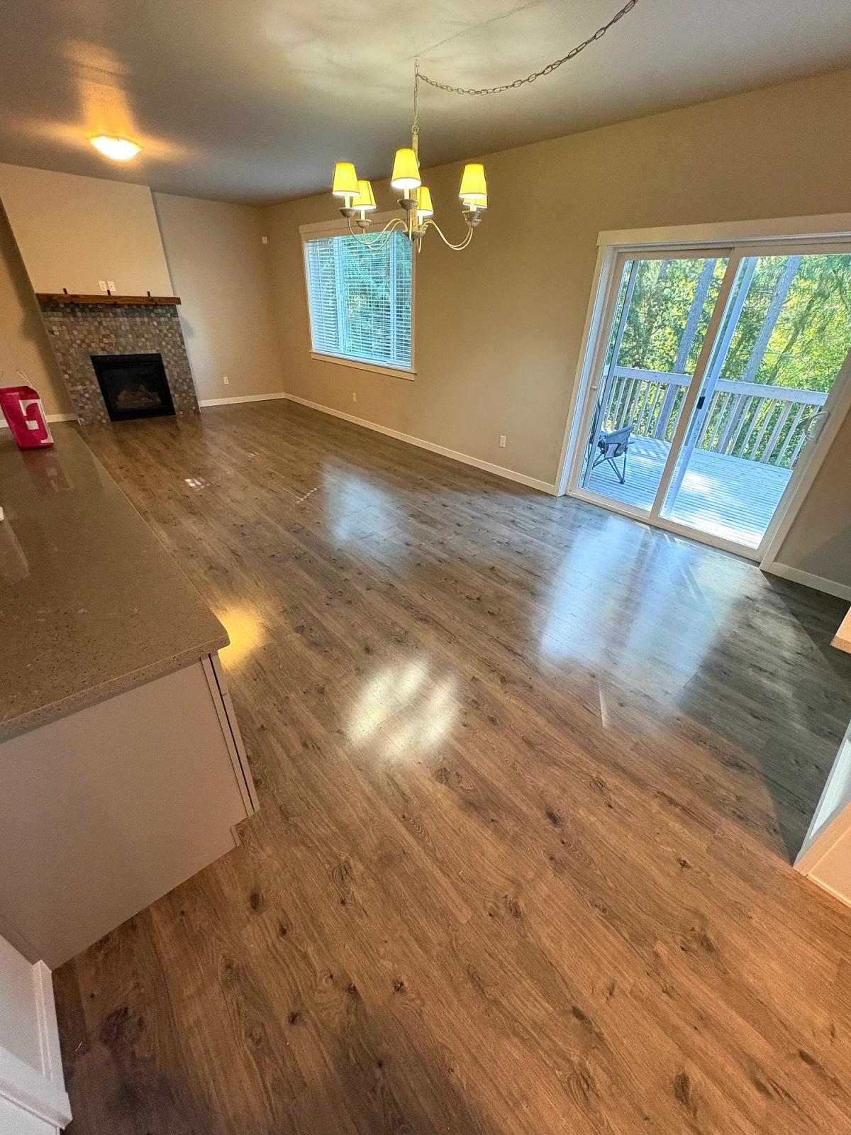 Dark laminate replaced with light wood-look LVP in the living area., before